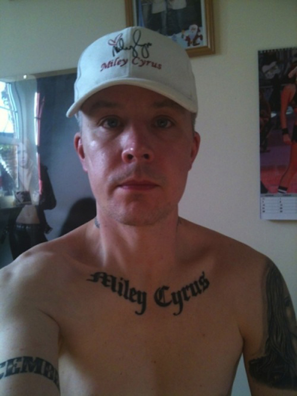 A man displaying a chest tattoo that uplifts your life.