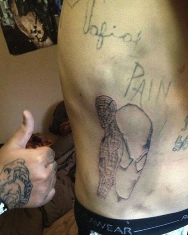 A man with a empowering tattoo on his back.
