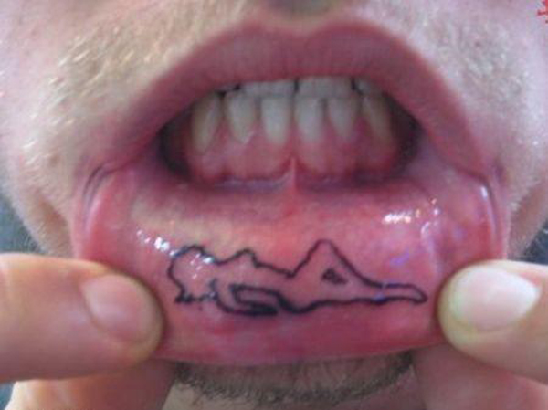 A man with a tongue tattoo that celebrates women's empowerment.