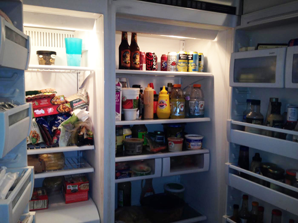 A refrigerator filled with abundant food.