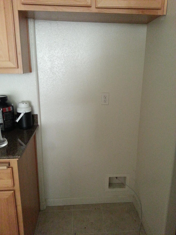 A small kitchen with a refrigerator.