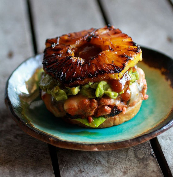 A visually stunning Super Bowl burger with pineapple and guacamole.