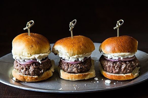 Three burger sliders with onions, perfect for Super Bowl.