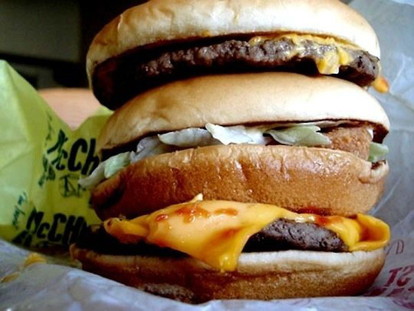 A visually stunning stack of McDonald's hamburgers, perfect for Super Bowl burger suggestions.