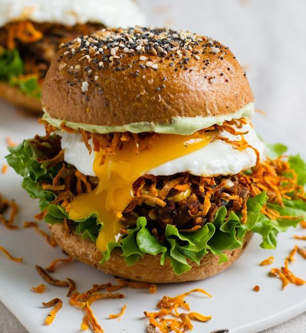 A visually appealing Super Bowl burger featuring a veggie patty topped with an egg.