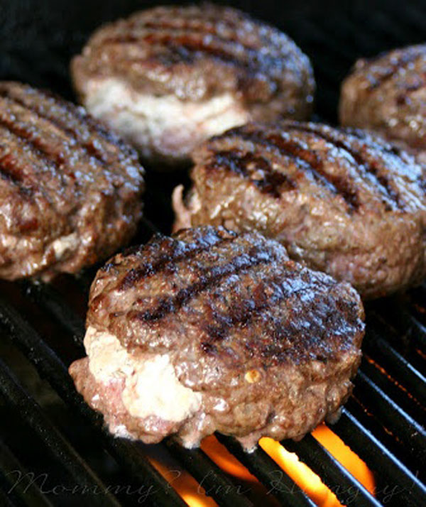 Awesome Super Bowl burgers on a grill.