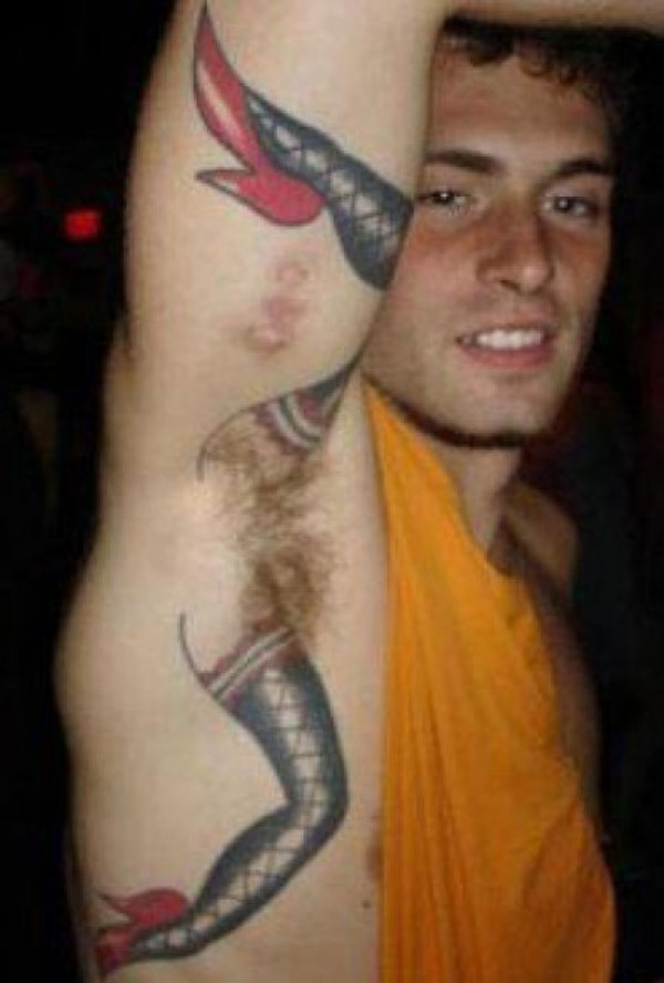 A man with a terrible tattoo on his arm that will make you happy you are you.