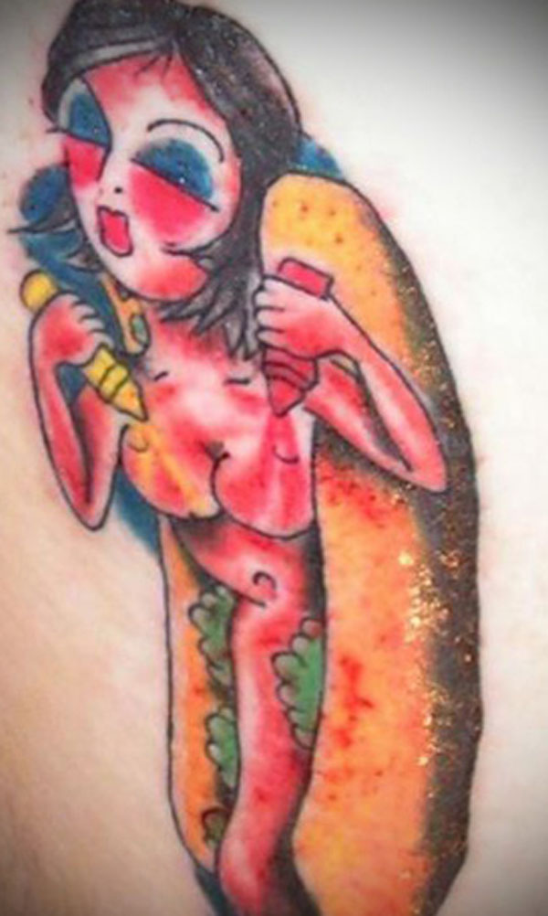 A terrible tattoo that features a woman with an unconventional hot dog design on her thigh.