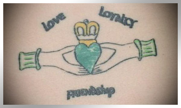 A tattoo featuring the words love, loyalty, and friendship.