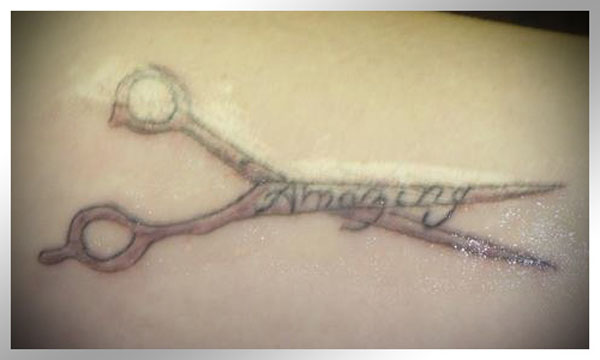 20 Terrible Tattoos That Will Make You Happy You Are You - Scissors with the word amygdala.