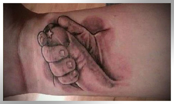 A tattoo of a person holding a hand that will make you happy.