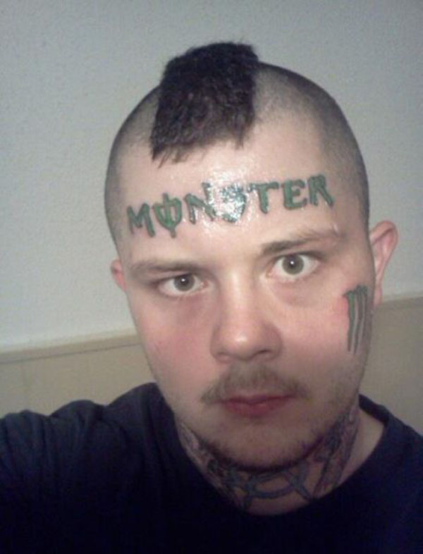 A man with a monstrous head tattoo.