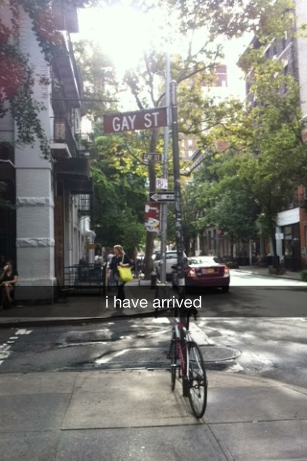 A bicycle is parked on a city street, capturing the attention of people who are doing Snapchat just right.