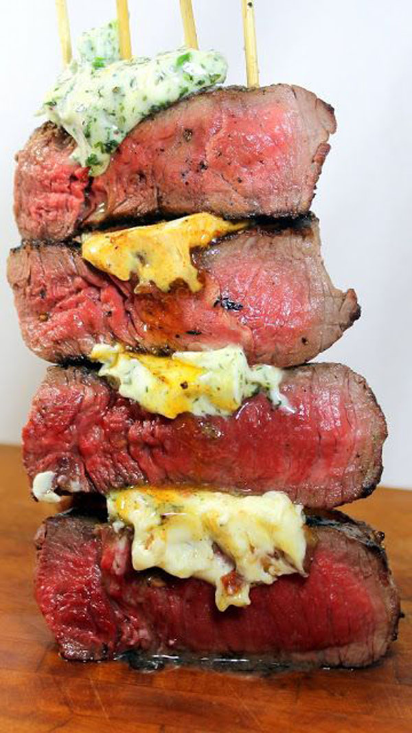 A stack of juicy steaks arranged appetizingly on a plate.