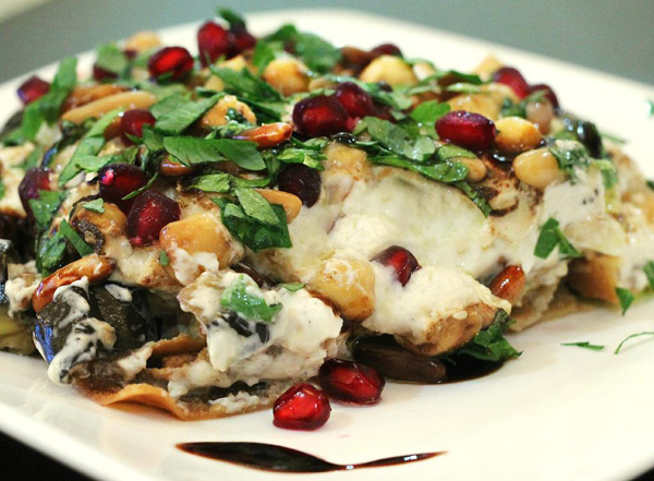 A tantalizing plate of food featuring nuts and pomegranate, perfect for food porn enthusiasts.