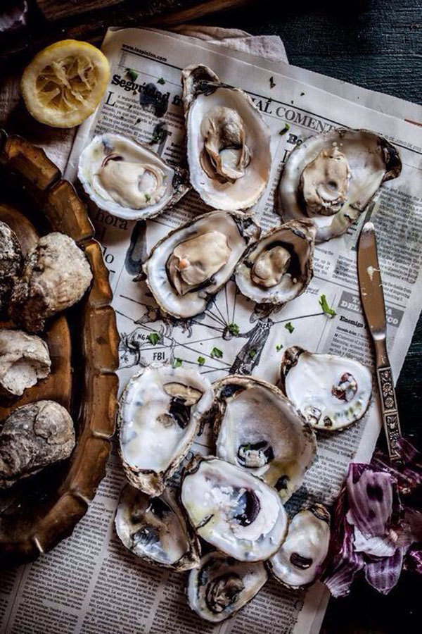 Oysters on a newspaper.
