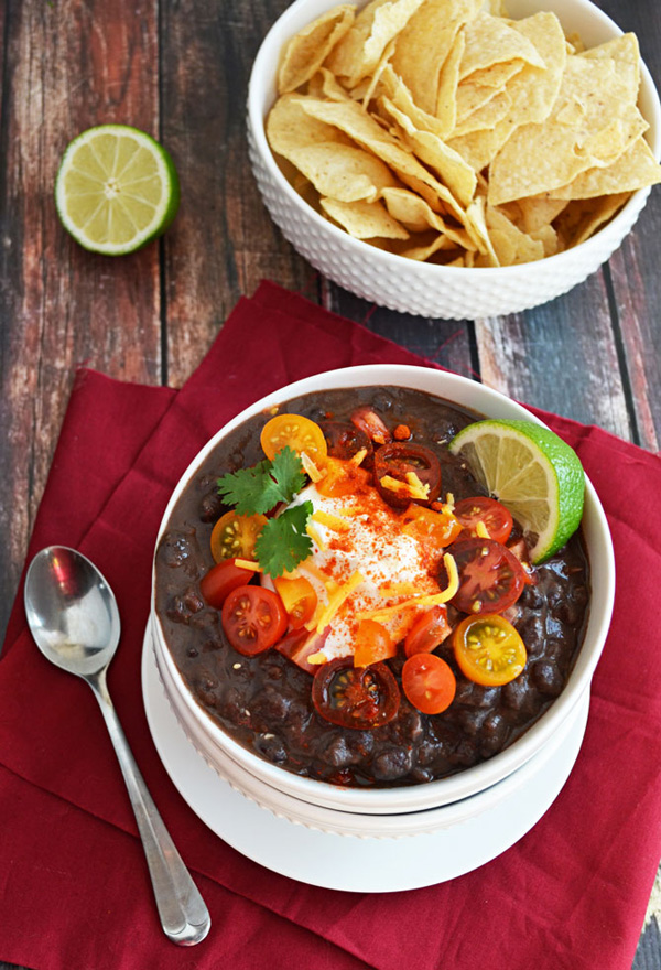 If You Love Food Porn: A delectable bowl of black bean soup adorned with juicy tomatoes and crispy tortilla chips.