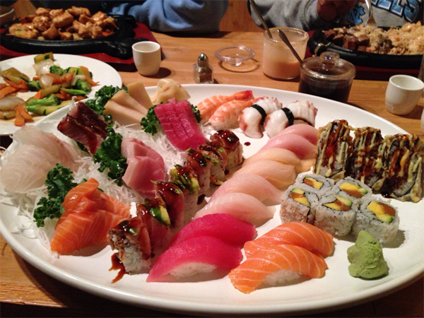 A decadent plate of sushi on a table, perfect for food porn enthusiasts.