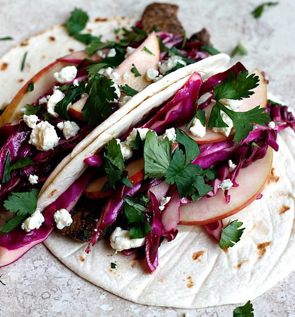 A mouthwatering taco featuring vibrant red cabbage and tangy feta cheese that will satisfy any food porn enthusiast.