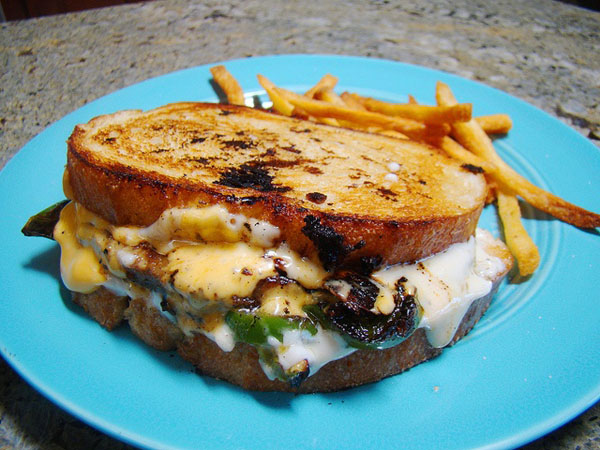 Hungry? Indulge in some food porn - a grilled sandwich on a blue plate.