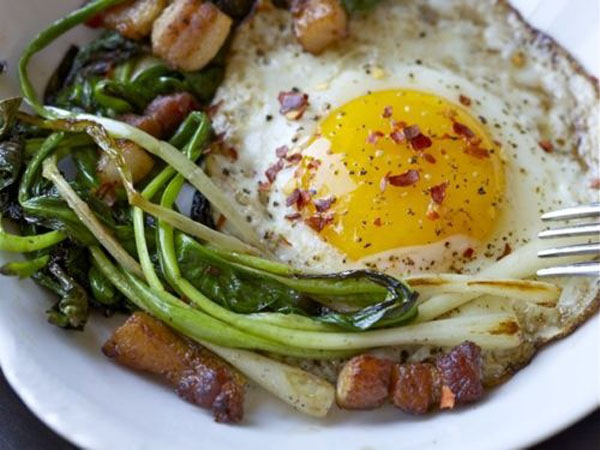 A plate of eggs and greens, perfect for satisfying your hunger.