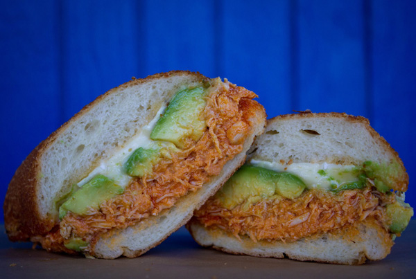 A mouthwatering sandwich featuring savory chicken and creamy avocado that will satisfy your food cravings.