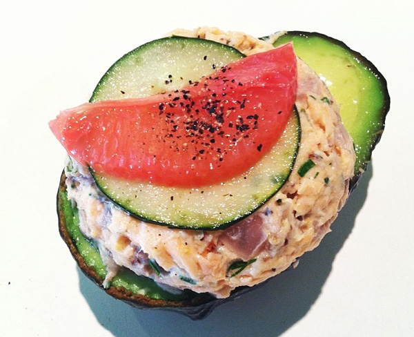 A tantalizing stuffed avocado loaded with tuna and cucumber, perfect for food porn enthusiasts.