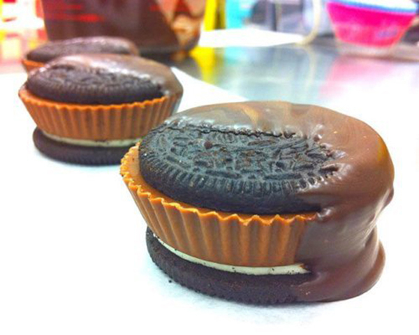 Hungry? Enjoy irresistible food porn with Oreo cupcakes topped with chocolate frosting.