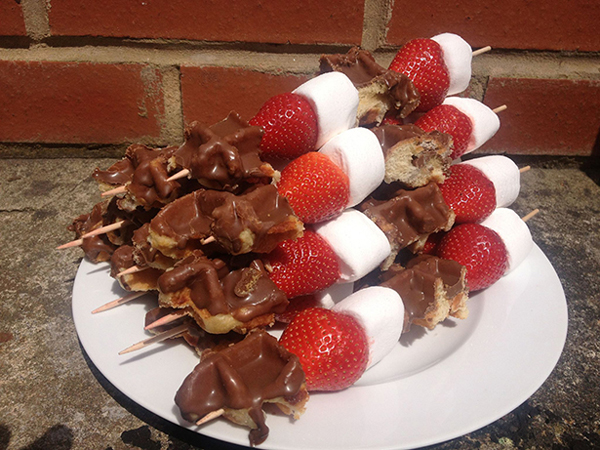 Chocolate covered strawberries on skewers that will make your mouth water.