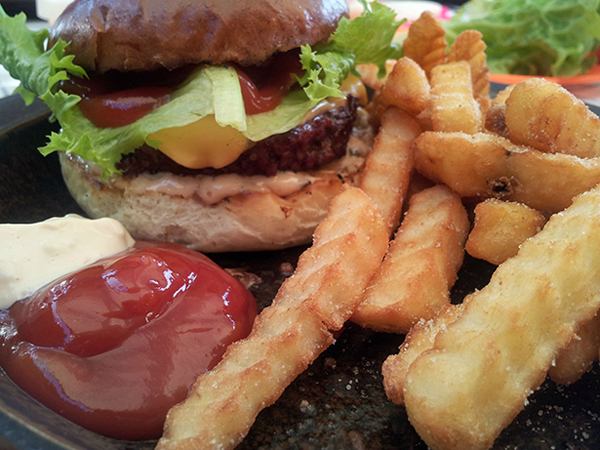 A mouthwatering burger on a plate.