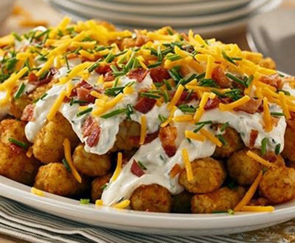 Game day grub idea: Cheesy tater tots with bacon and sour cream.