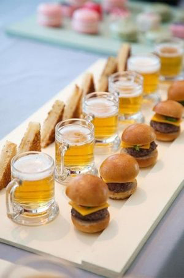 Game Day Grub Ideas: A tray of sliders and beer in honor of football on a table.
