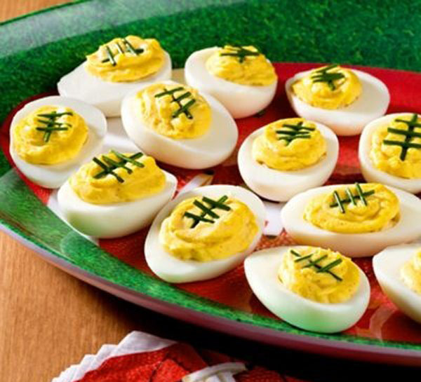 In Honor of Football, serving Game Day Grub Ideas with deviled eggs shaped like footballs on a plate.