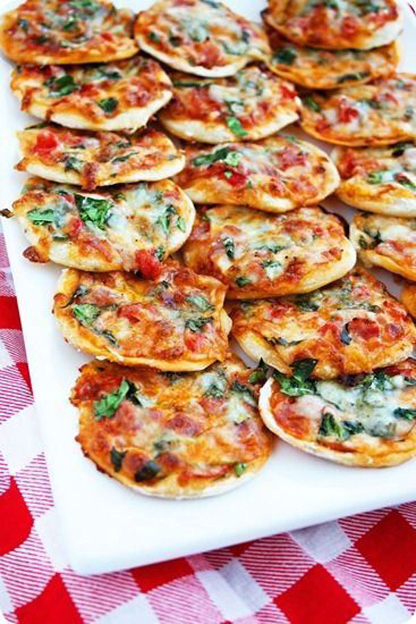Game day grub ideas: Mini pizzas on a checkered tablecloth.