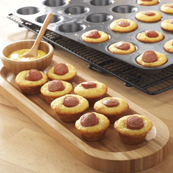 Game day grub idea: Hot dog muffins with mustard, served on a tray.
