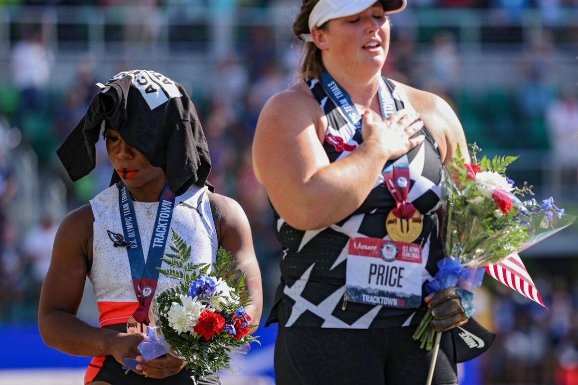 Two women showcasing the true essence of the Olympics through holding flowers on a track.