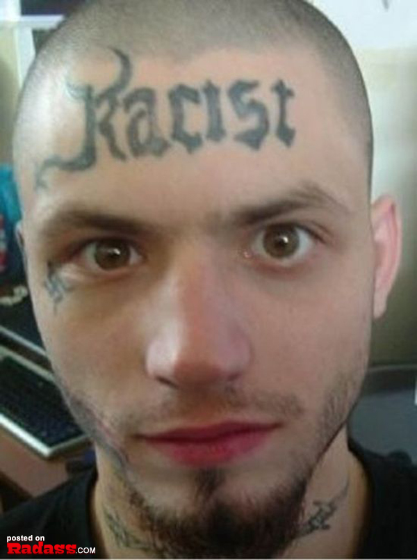 A man with a regrettable racist tattoo on his head.