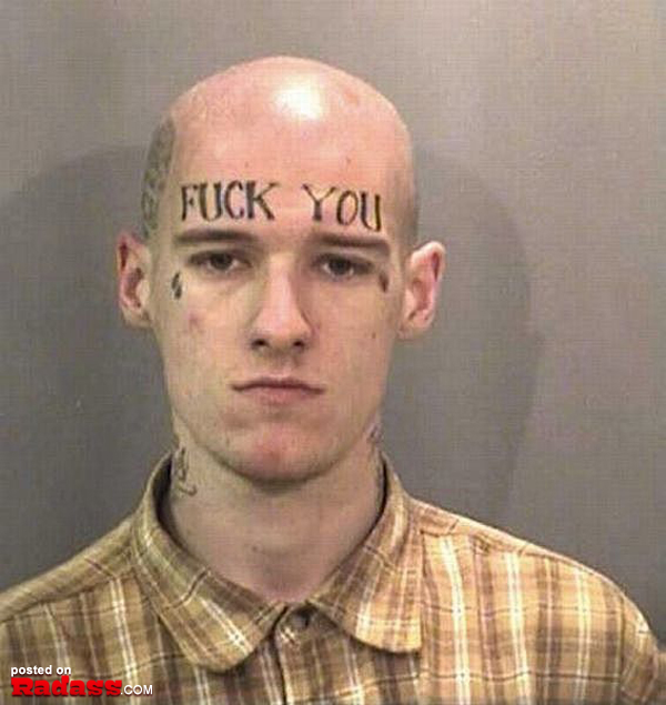A man with a regrettable tattoo on his head featuring the words 