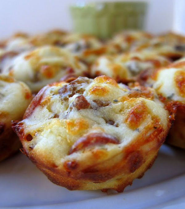 Cheesy pizza muffins presented on a white plate in an OM-F@cking-G Food Porn manner.