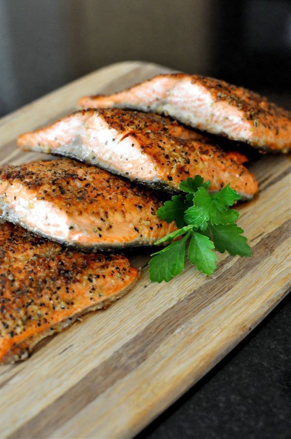 Four pieces of salmon on a cutting board, OM-F@cking-G Food Porn.