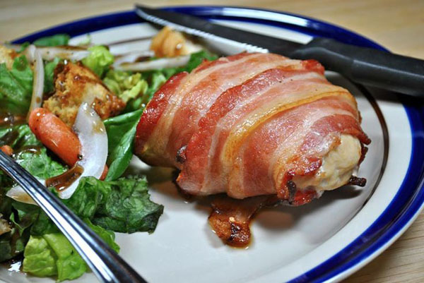 Bacon wrapped chicken served with salad - food porn.