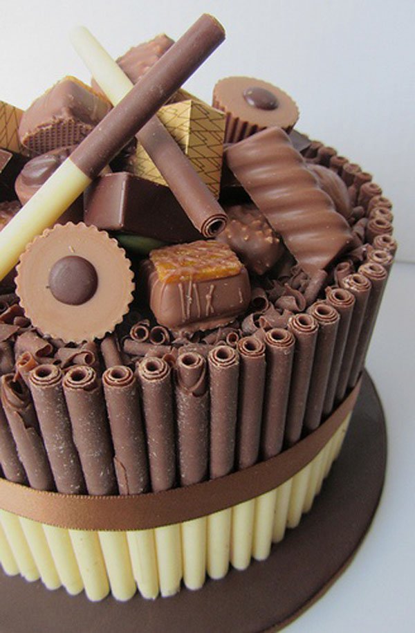 OM-F@cking-G: A decadent chocolate cake adorned with luscious chocolate sticks and an abundance of mouth-watering chocolates, truly a feast for the senses.