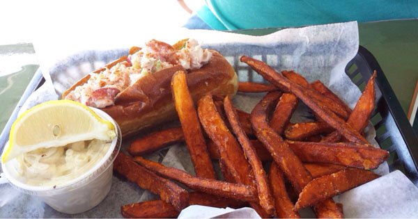 A tray with OMG-worthy hot dog and sweet potato fries.