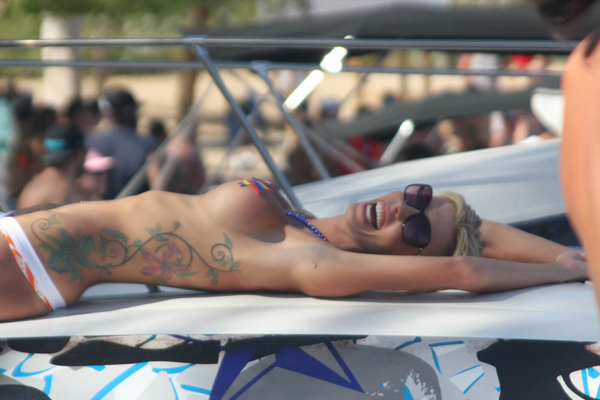 A woman in a bikini lounging on a boat, showcasing the best of summer 2014.