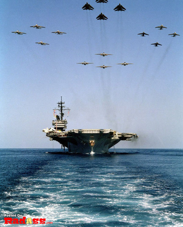 A group of American Heroes planes flying over a ship.