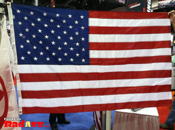 An American hero holds an American flag at a convention.