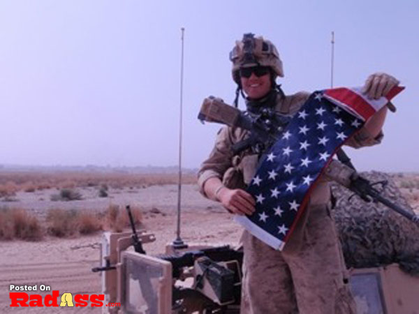 A salute to the American heroes - soldier holding an American flag in the desert.