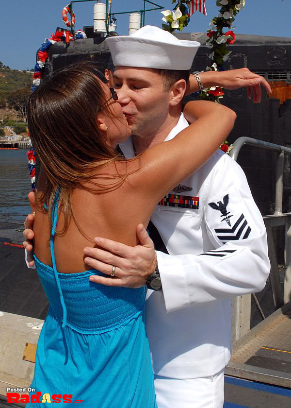 American Heroes kissing woman in navy uniform.