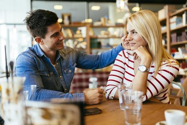 A couple discussing their deal-breakers amidst a cafe meeting.