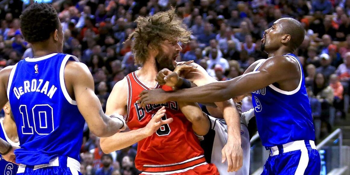 NBA players engaged in an intense struggle over the ball.